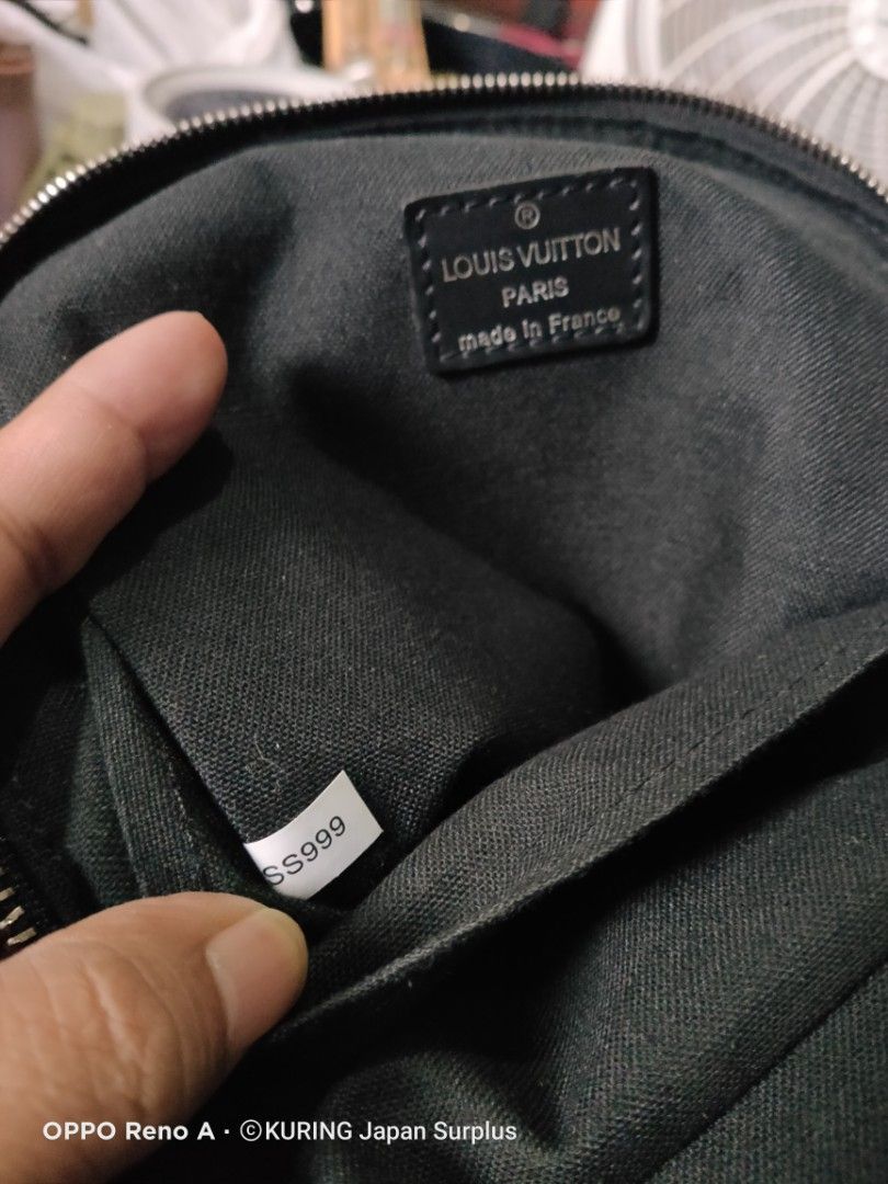 Louis Vuitton Damier Graphite Sling Bag (Category: Luxury Bags & Wallets) located in Batangas. Submitted by ems10. (Listing ID 1404810091, Image 2). Description: Authentic Louis Vuitton Damier Graphite sling bag. Features a checkered pattern with multiple patches. Includes a main compartment with a zipper closure and an adjustable strap. The interior has a small pocket and a Louis Vuitton label. Made in France. The bag has silver-tone hardware an