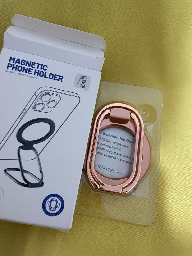 Magnetic Phone Holder - Rose Gold (Category: Mounts & Holders) located in Manila. Submitted by winnieyols (Listing ID 1404905825, Image 2). Description: Magnetic phone holder is designed for iPhone 12/13/14 series and MagSafe phone cases. It features a built-in strong magnet for secure attachment and a foldable design for multi-angle usage. The holder allows for easy stick-on and take-down, and it does not affect wireless charging. The color is r