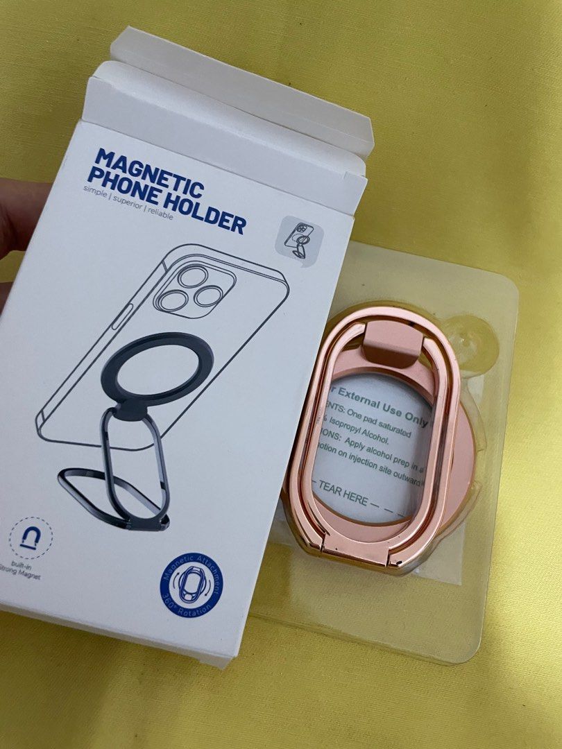 Magnetic Phone Holder - Rose Gold (Category: Mounts & Holders) located in Manila. Submitted by winnieyols (Listing ID 1404905825, Image 1). Description: Magnetic phone holder is designed for iPhone 12/13/14 series and MagSafe phone cases. It features a built-in strong magnet for secure attachment and a foldable design for multi-angle usage. The holder allows for easy stick-on and take-down, and it does not affect wireless charging. The color is r