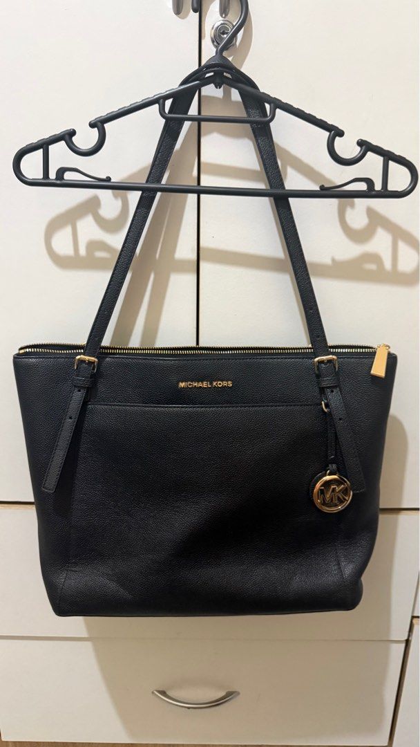 Michael Kors Voyager Tote Bag - Black (Category: Tote Bags) located in Marikina City. Submitted by DaaanDanDan (Listing ID 1404920948, Image 2). Description: - Authentic Michael Kors Voyager tote bag - Color: Black - Features zip closure - Multiple interior pockets - Gold-tone MK charm - Includes care card and original tag - Spacious interior - Made of leather - Classic design - Perfect for everyday use - Can fit 13-in laptop Bought for Php 4600.