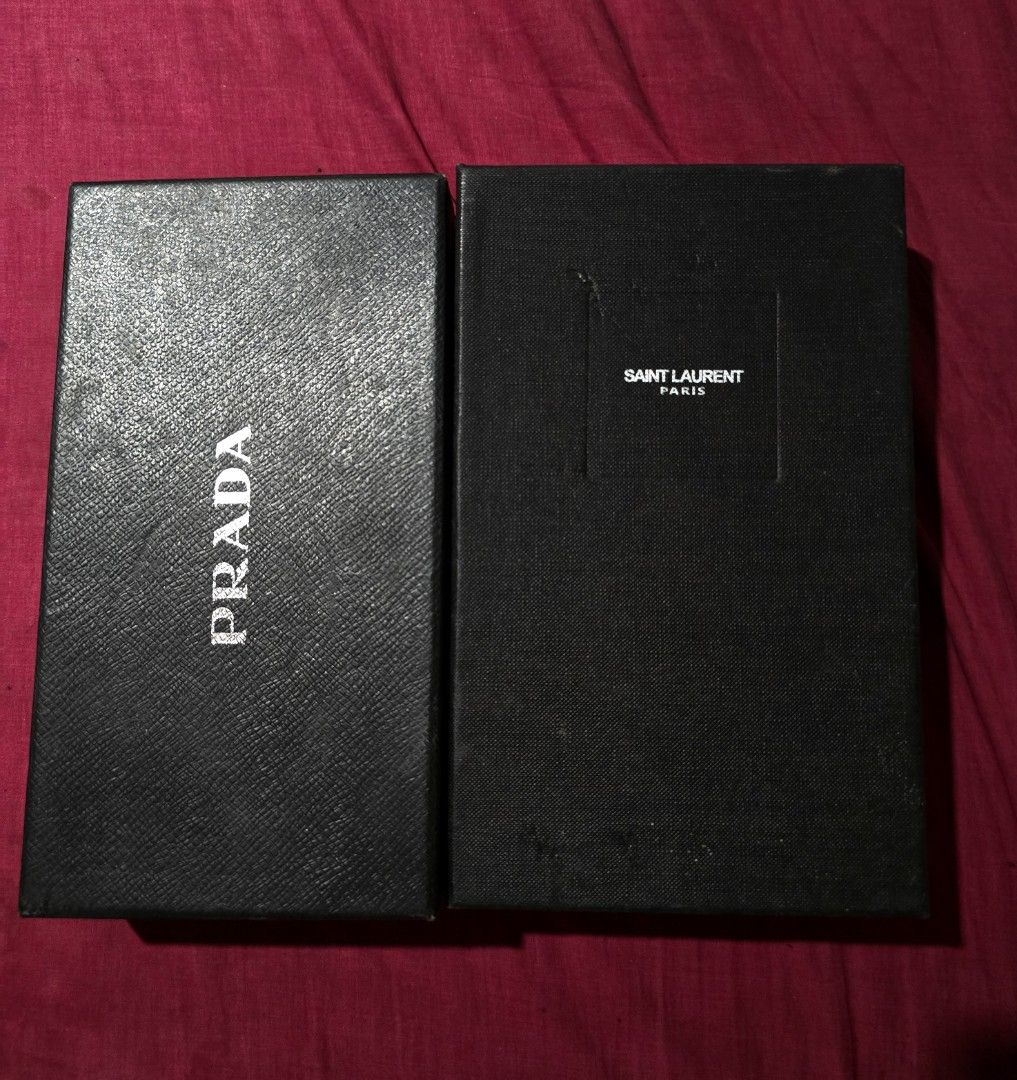 Prada and Saint Laurent Boxes (Category: Luxury Accessories) located in Batangas. Submitted by thevanitychamber (Listing ID 1404957098, Image 1). Description: - Two designer boxes available: Prada and Saint Laurent Paris. - Color: Black - Branding: White print of brand name on each box. - Condition: Good.