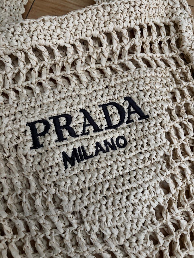 Prada Milano Woven Tote Bag (Category: Luxury Bags & Wallets) located in Manila. Submitted by louievicocollections (Listing ID 1404938868, Image 3). Description: - Prada tote bag - Woven design - Prada Milano logo displayed - Two handles for carrying - Spacious interior - Light-colored woven material.