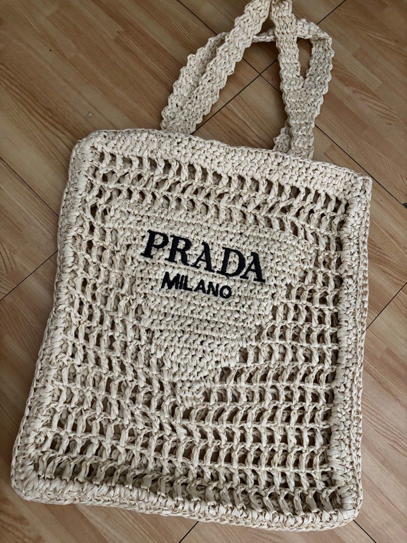 Prada Milano Woven Tote Bag (Category: Luxury Bags & Wallets) located in Manila. Submitted by louievicocollections (Listing ID 1404938868, Image 2). Description: - Prada tote bag - Woven design - Prada Milano logo displayed - Two handles for carrying - Spacious interior - Light-colored woven material.