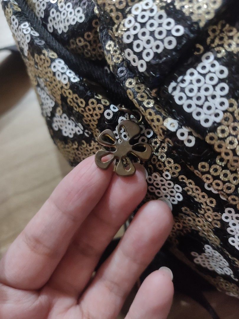 Sequin Leopard Print Backpack (Category: Backpacks) located in Port Klang. Submitted by hagumi (Listing ID 1404885729, Image 2). Description: - Leopard print with sequins - Top handle and adjustable shoulder straps - Flower charm zipper pull - Black back, straps, and handle - Small size, perfect for essentials.