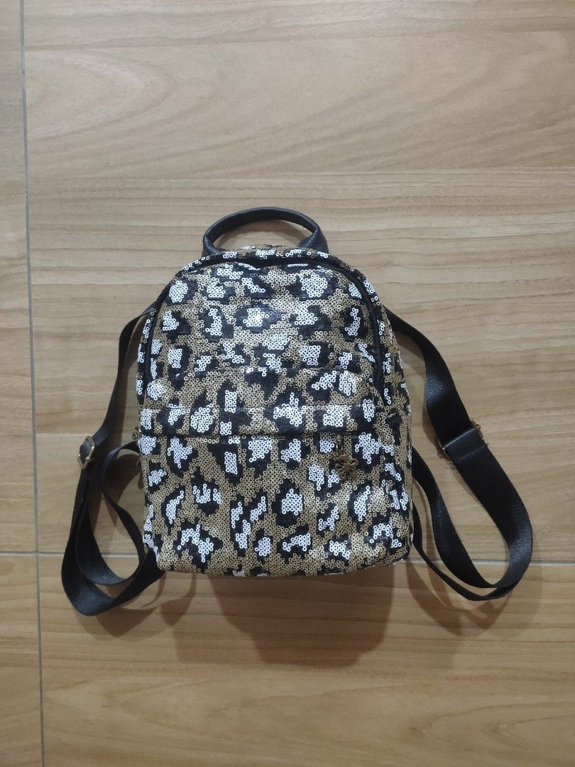 Sequin Leopard Print Backpack (Category: Backpacks) located in Port Klang. Submitted by hagumi (Listing ID 1404885729, Image 1). Description: - Leopard print with sequins - Top handle and adjustable shoulder straps - Flower charm zipper pull - Black back, straps, and handle - Small size, perfect for essentials.
