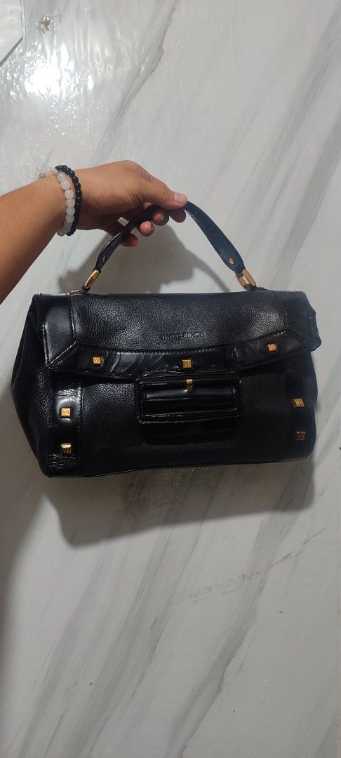 Vincis Bench Black Handbag (Category: Luxury Bags & Wallets) located in Rizal. Submitted by chicout (Listing ID 1404905857, Image 1). Description: - Vincis Bench black handbag - Ykk zipped - Features a top handle - Flap closure - Interior with patterned lining and zippered pocket - Gold-toned hardware (studs, zippers) - Rectangular shape.