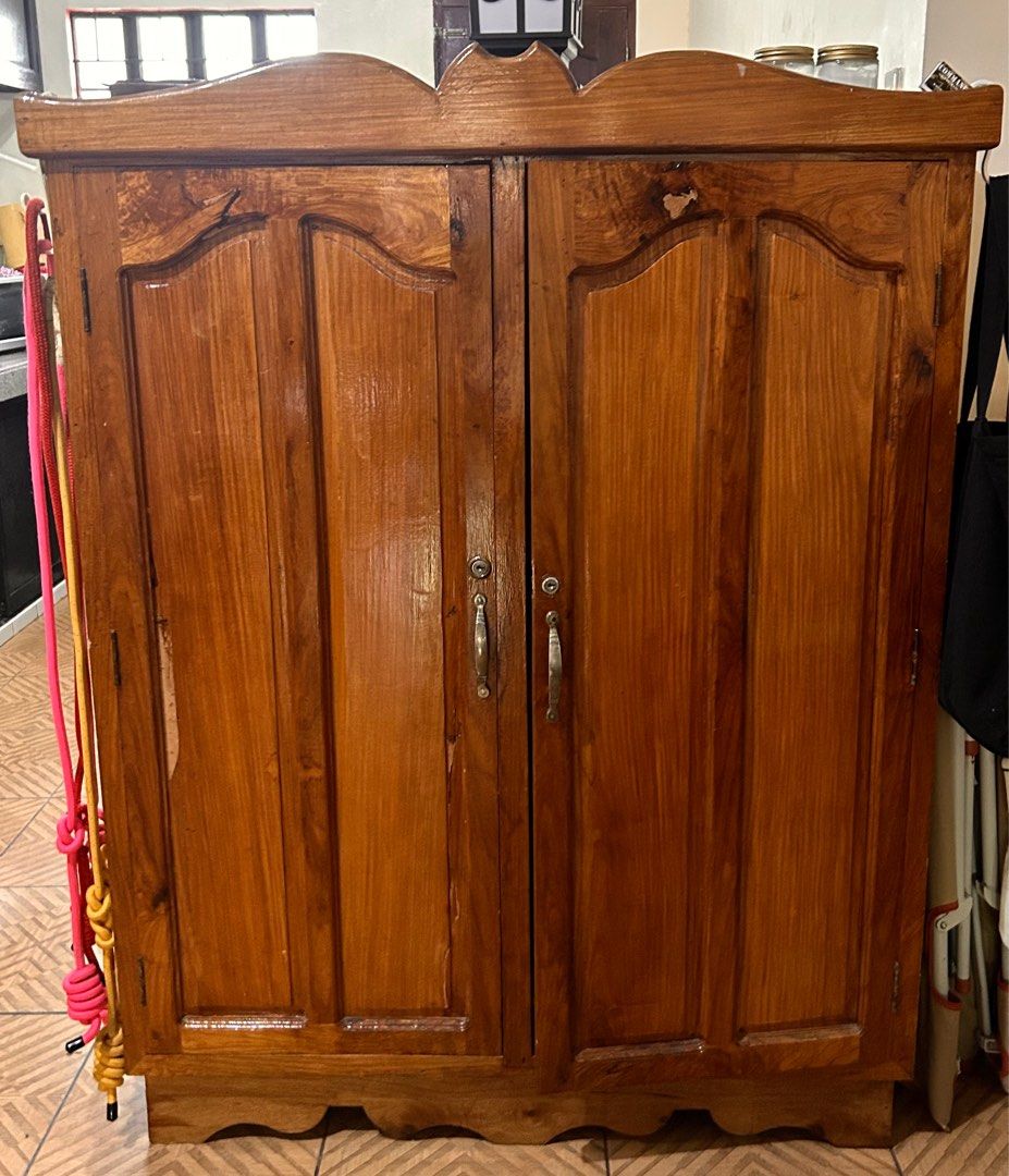 Wooden Cabinet with Two Doors (Category: Shelves, Cabinets & Racks) located in Quezon City. Submitted by albertgtaule (Listing ID 1404860685, Image 1). Description: Hello! I am selling this cabinet for ₱15,000, slightly negotiable. It’s made of pure narra wood. Buyer will arrange and shoulder the transport fee. Reason for selling: We are doing a total house renovation, and it no longer matches the theme of our new home. Location: Brgy. Bukal, Pag