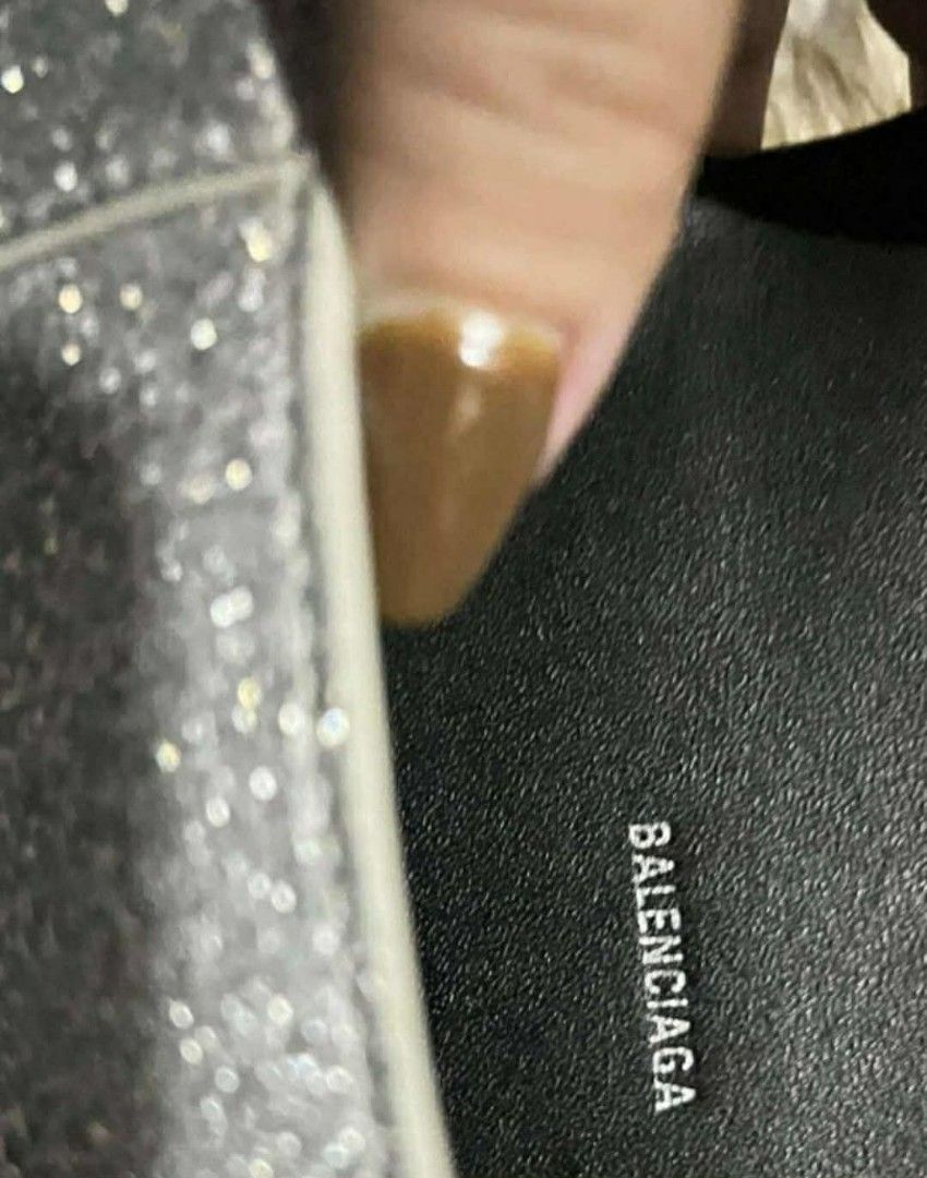 Balenciaga Hourglass Glitter Bag (Category: Luxury Bags & Wallets) located in Legazpi City. Submitted by georgepine07142 (Listing ID 1405149926, Image 3). Description: The Balenciaga Glitter Hourglass Small Top Handle Bag is a stunning piece to elevate your Balenciaga collection. Made from glitter fabric with its signature structured hourglass silhouette, it features sleek curves, matte hardware, and a lambskin-lined interior that truly set it ap
