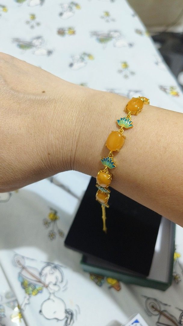 Beeswax Bracelet with Lotus Flower (Category: Bracelets) located in Antipolo. Submitted by shopbyey (Listing ID 1405119093, Image 3). Description: - Gold-toned bracelet - Features oval-shaped orange stones - Delicate blue and green floral details - Comes in original box - Perfect for any occasion.