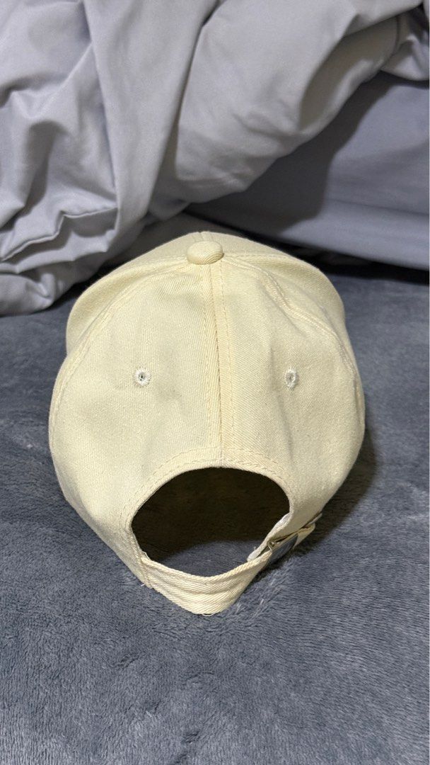 Cap (Category: Caps & Hats) located in Singapore. Submitted by tommyyee6 (Listing ID 1405123404, Image 4). Description: - Cream-colored baseball cap - Features the NY Yankees logo - Adds sporty style to your outfit - Adjustable strap for a comfortable fit.