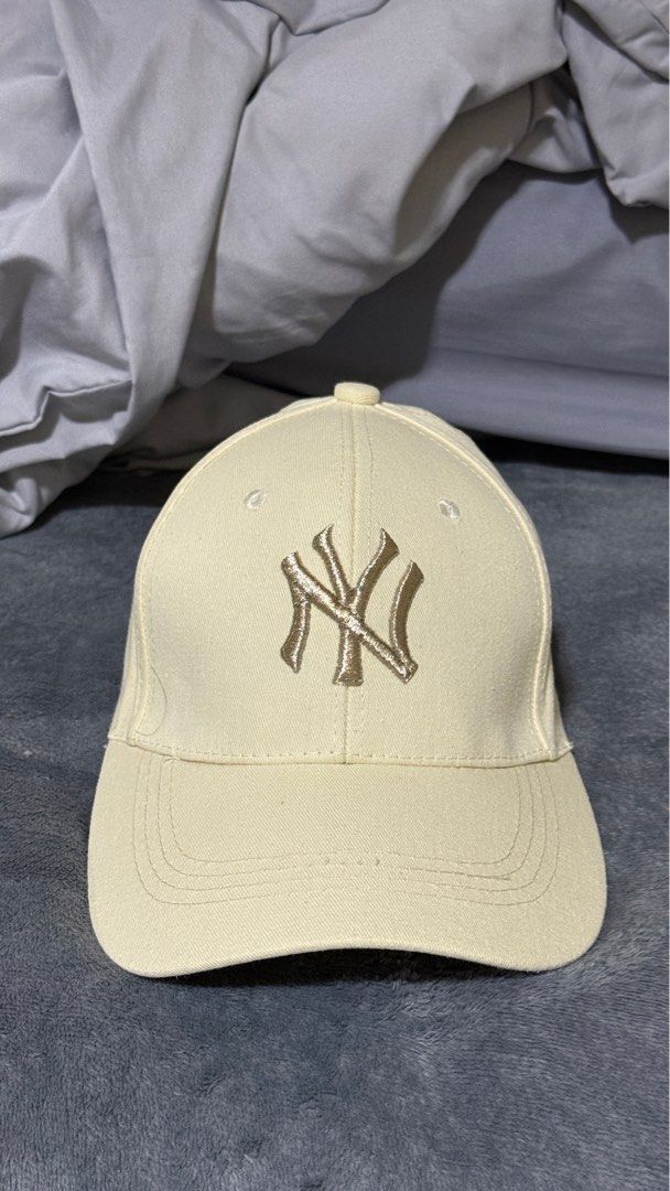 Cap (Category: Caps & Hats) located in Singapore. Submitted by tommyyee6 (Listing ID 1405123404, Image 3). Description: - Cream-colored baseball cap - Features the NY Yankees logo - Adds sporty style to your outfit - Adjustable strap for a comfortable fit.
