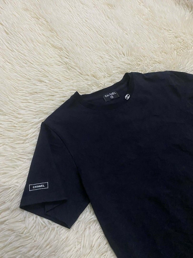 Chanel Black T-shirt (Category: Luxury Apparel) located in Manila. Submitted by switchcity (Listing ID 1405091865, Image 2). Description: - Chanel T-shirt - Classic black color - Features small Chanel logo on chest - Chanel label on sleeve - Size and product code visible on tag - Made of soft, comfortable material - Perfect for everyday wear - Stylish and versatile.