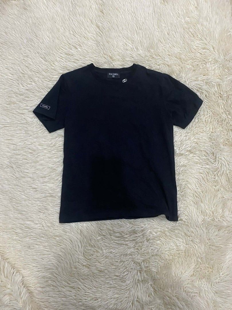Chanel Black T-shirt (Category: Luxury Apparel) located in Manila. Submitted by switchcity (Listing ID 1405091865, Image 1). Description: - Chanel T-shirt - Classic black color - Features small Chanel logo on chest - Chanel label on sleeve - Size and product code visible on tag - Made of soft, comfortable material - Perfect for everyday wear - Stylish and versatile.