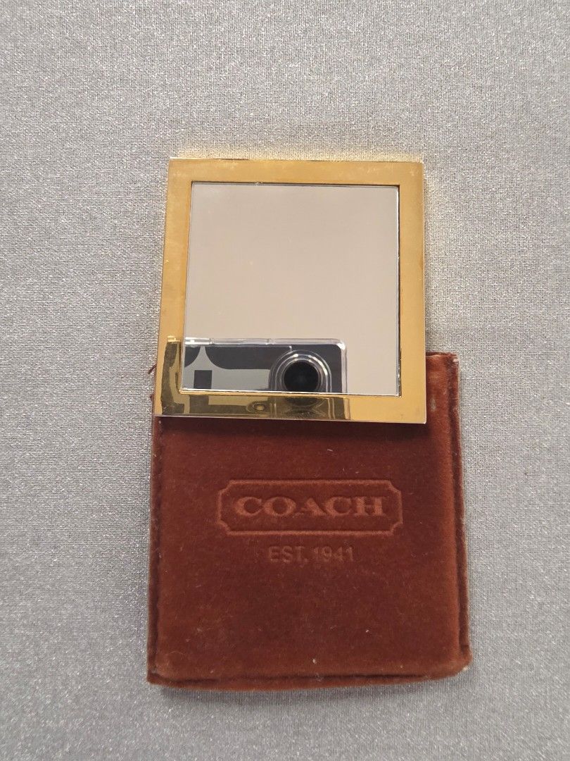 Coach Compact Mirror (Category: Mirrors) located in Mandaue City. Submitted by scarletnate_eshop (Listing ID 1405041184, Image 3). Description: - Gold-tone Coach compact mirror - Comes with a brown, velvet-like case - Coach logo displayed on mirror and case - Square-shaped mirror - Free shipping.