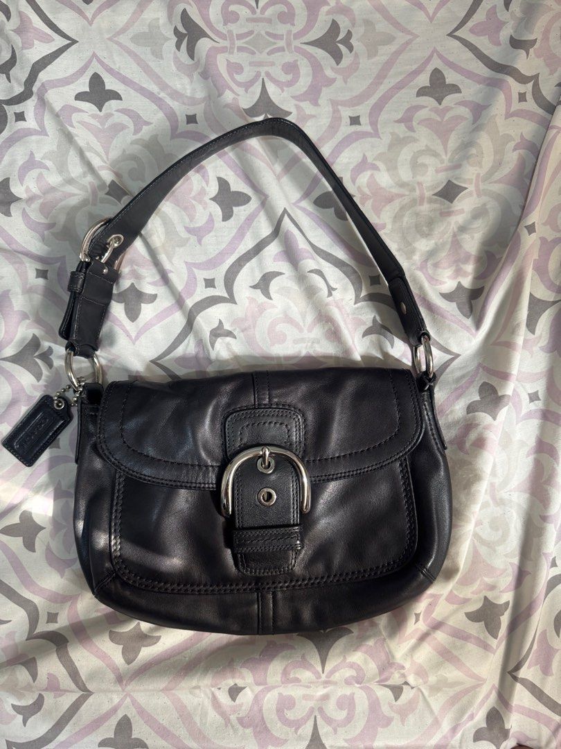 Coach Soho Bag(medium) (Category: Luxury Bags & Wallets) located in Batac City. Submitted by y4na4lbn (Listing ID 1404986034, Image 1). Description: - Coach black leather shoulder bag - Flap closure with silver buckle - Detachable Coach tag included - Single shoulder strap - Silver hardware - Minor mark on exterior.