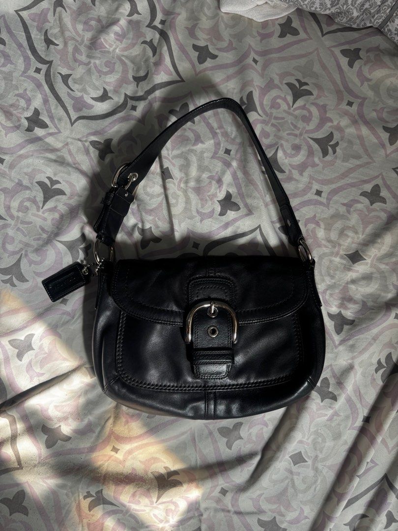 Coach Soho Bag(medium) (Category: Luxury Bags & Wallets) located in Batac City. Submitted by y4na4lbn (Listing ID 1404986034, Image 2). Description: - Coach black leather shoulder bag - Flap closure with silver buckle - Detachable Coach tag included - Single shoulder strap - Silver hardware - Minor mark on exterior.