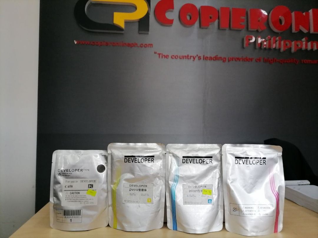 Developer Toner Cartridges For C-Series (Category: Printers, Scanners & Copiers) located in Quezon City. Submitted by copieronlineinc (Listing ID 1404989286, Image 3). Description: - Developer toner cartridge set - Includes: black, yellow, cyan, and magenta cartridges - Each cartridge labeled "DEVELOPER" - Black cartridge: C458 - Other cartridges: DV512.
