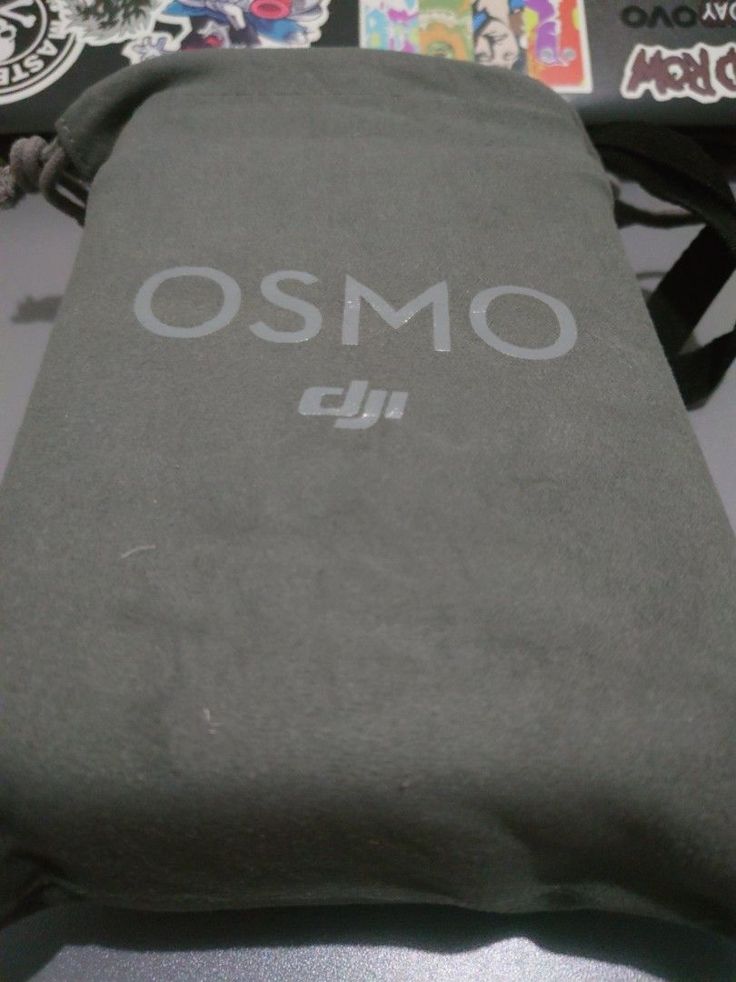 DJI Osmo Mobile Gimbal Stabilizer (Category: Gimbals & Stabilizers ) located in Mandaluyong City. Submitted by iamador (Listing ID 1405126375, Image 1). Description: - DJI Osmo Mobile gimbal stabilizer - Includes: gimbal, carrying case, and soft pouch - Color: Gray - Condition: Good - Features control buttons on the handle - Carrying case and soft pouch feature the Osmo logo.