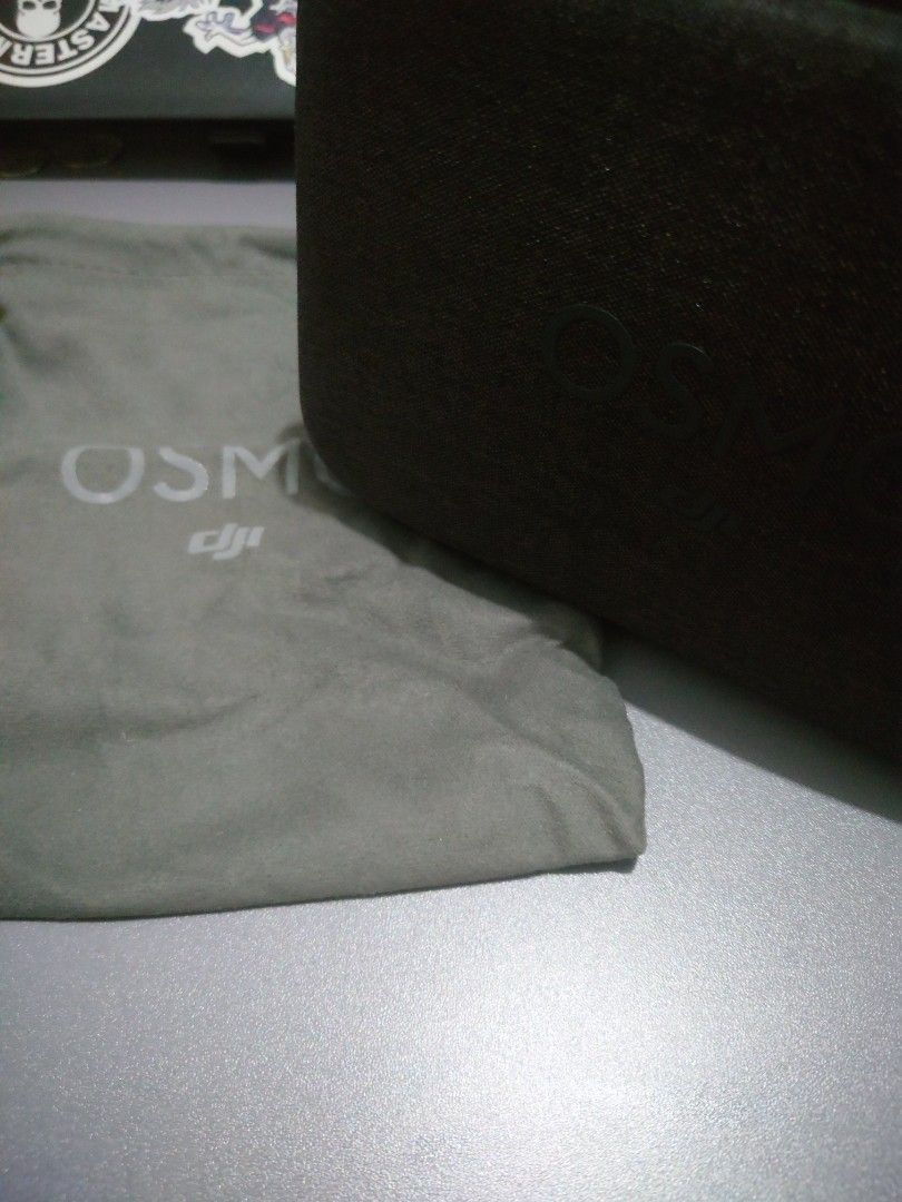DJI Osmo Mobile Gimbal Stabilizer (Category: Gimbals & Stabilizers ) located in Mandaluyong City. Submitted by iamador (Listing ID 1405126375, Image 2). Description: - DJI Osmo Mobile gimbal stabilizer - Includes: gimbal, carrying case, and soft pouch - Color: Gray - Condition: Good - Features control buttons on the handle - Carrying case and soft pouch feature the Osmo logo.