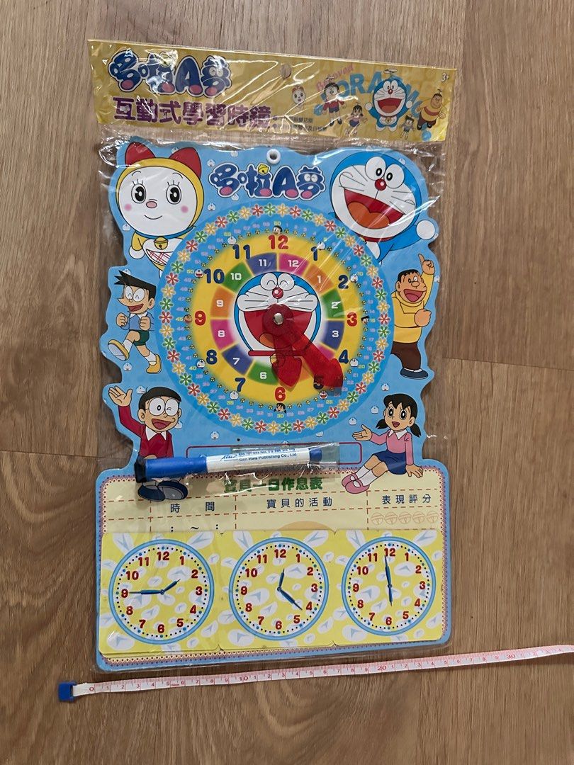 Doraemon Interactive Learning Clock (Category: Educational & Learning Toys) located in Singapore. Submitted by yanandneko (Listing ID 1405086662, Image 4). Description: - Brand new Doraemon learning clock - Interactive design for kids - Includes a whiteboard marker - Features Doraemon and friends - Great for learning to tell time - Packaging has Chinese text on the back.