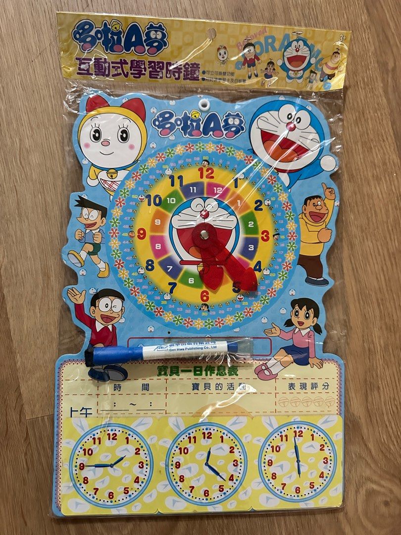 Doraemon Interactive Learning Clock (Category: Educational & Learning Toys) located in Singapore. Submitted by yanandneko (Listing ID 1405086662, Image 1). Description: - Brand new Doraemon learning clock - Interactive design for kids - Includes a whiteboard marker - Features Doraemon and friends - Great for learning to tell time - Packaging has Chinese text on the back.