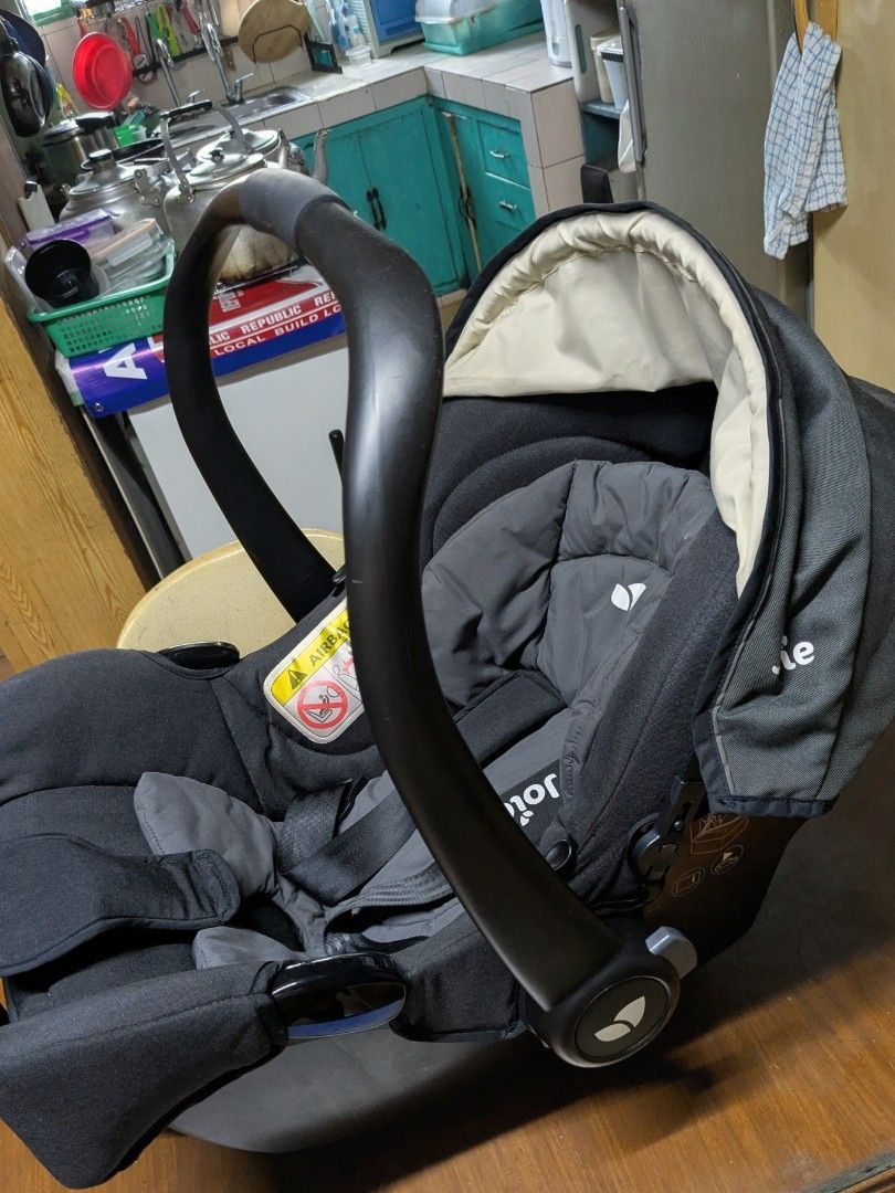 Joie Infant Car Seat (Category: Car Seats) located in Quezon City. Submitted by rlscg (Listing ID 1405112486, Image 2). Description: - Joie infant car seat - Dark grey fabric - Matching headrest and harness - Curved carrying handle - Integrated sunshade - Safety warning sticker - Joie logo visible - compatible with joolz aer strollers.