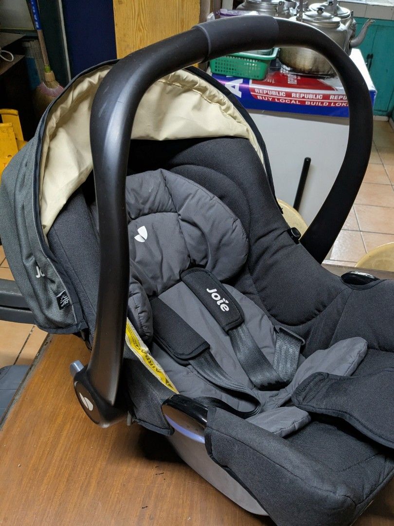 Joie Infant Car Seat (Category: Car Seats) located in Quezon City. Submitted by rlscg (Listing ID 1405112486, Image 1). Description: - Joie infant car seat - Dark grey fabric - Matching headrest and harness - Curved carrying handle - Integrated sunshade - Safety warning sticker - Joie logo visible - compatible with joolz aer strollers.