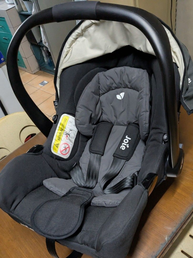 Joie Infant Car Seat (Category: Car Seats) located in Quezon City. Submitted by rlscg (Listing ID 1405112486, Image 3). Description: - Joie infant car seat - Dark grey fabric - Matching headrest and harness - Curved carrying handle - Integrated sunshade - Safety warning sticker - Joie logo visible - compatible with joolz aer strollers.