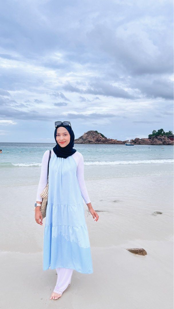 Light blue dress (Category: Dresses) located in Kuala Lumpur. Submitted by isntitdarling (Listing ID 1405028362, Image 1). Description: - Light blue tiered midi dress - Flowy design - Halter neckline - Layered skirt - Includes a white long-sleeved top - Ideal for beach days and casual outings - Comfortable and stylish.