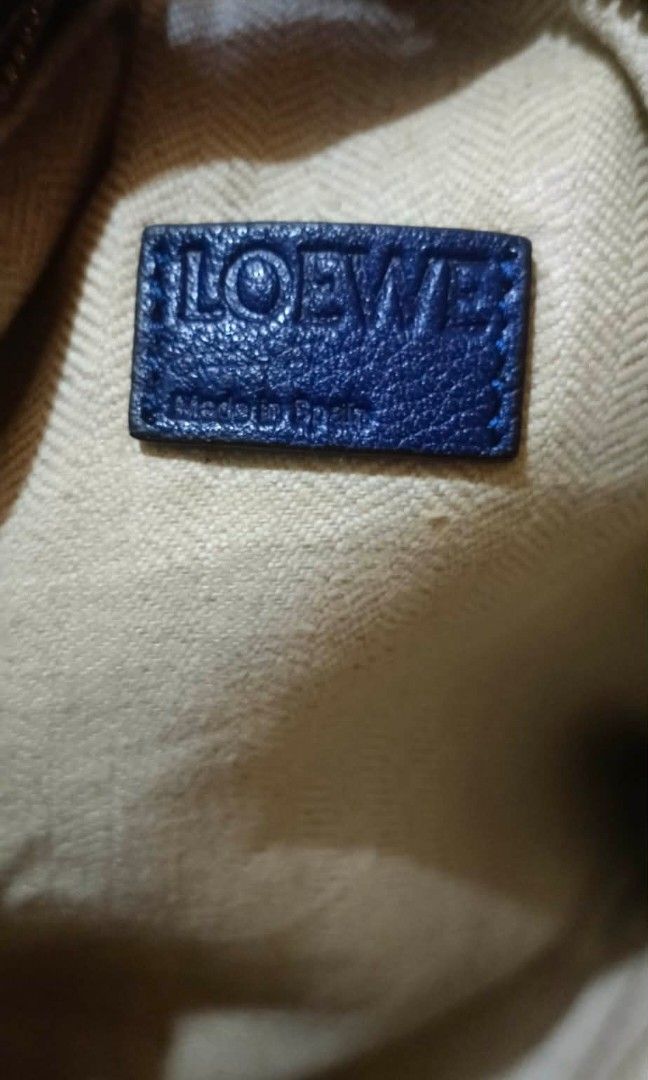 loewe pouch/clutch (Category: Luxury Bags & Wallets) located in Legazpi City. Submitted by georgepine07142 (Listing ID 1405150417, Image 3). Description: Preloved Loewe Pouch Clutch A stylish and functional piece designed to keep your essentials and accessories in one elegant pouch. Comes with its code and brand label inside. Shows signs of usage but still in good, usable condition. A chic Loewe classic perfect for everyday carry..