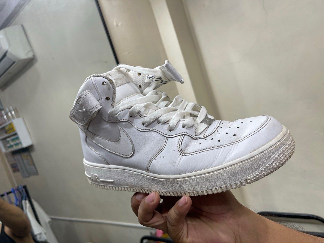 Nike Air Force 1 Mid White (Category: Sneakers) located in Lupao. Submitted by jennylynda42204 (Listing ID 1404968802, Image 3). Description: - White Nike Air Force 1 Mid sneakers - Iconic Nike swoosh - Mid-top design with strap - Visible wear on soles and uppers - White laces.