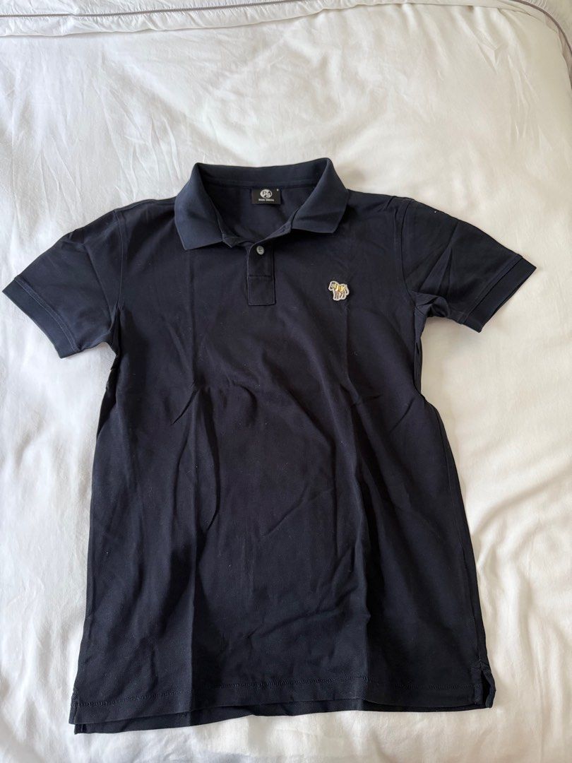 Paul Smith Zebra Logo Polo Shirt (Category: Tshirts & Polo Shirts ) located in Manila. Submitted by inob2024 (Listing ID 1405107847, Image 1). Description: - Paul Smith polo shirt in navy blue. - Features a classic collar and short sleeves. - Includes a three-button placket. - Embroidered with the Paul Smith zebra logo. - Made from comfortable fabric. - Perfect for casual wear..