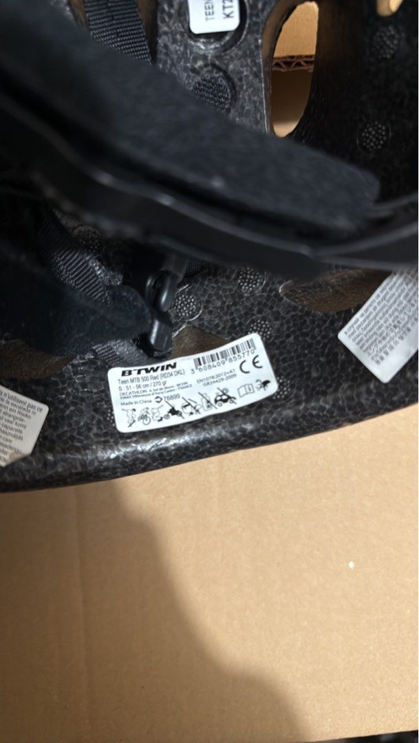 Rockrider MTB 500 Helmet (Category: Other Sports Equipment and Supplies) located in Taguig. Submitted by lalohan (Listing ID 1405002615, Image 2). Description: Rockrider MTB 500 helmet is designed for mountain biking. It features a white and black color scheme with multiple vents for airflow. The helmet has an adjustable strap system for a secure fit. The interior includes padding for comfort. The helmet is a size Teen and has a visor..