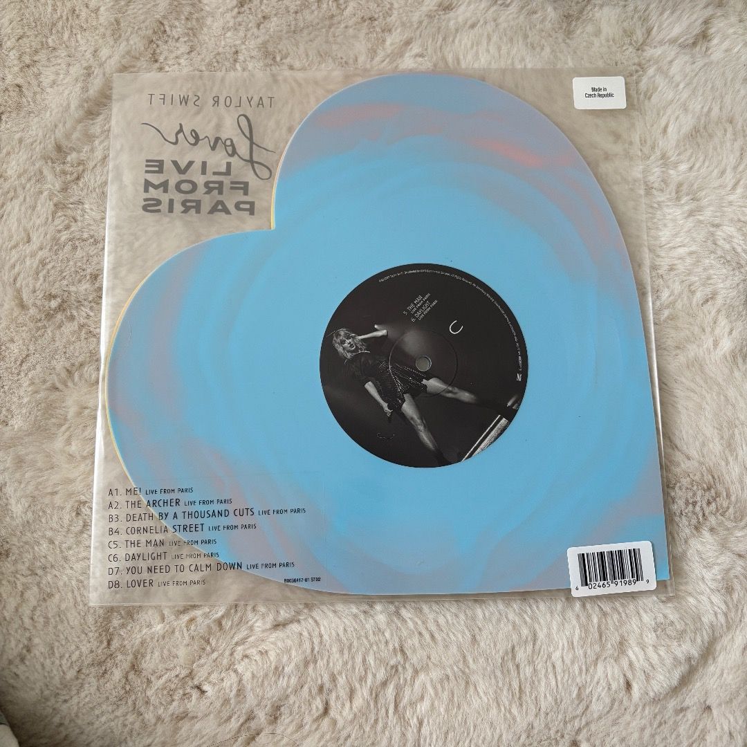 Taylor Swift Lover Live From Paris Vinyl (Category: Vinyls) located in Manila. Submitted by chapterthings (Listing ID 1404966114, Image 2). Description: Taylor Swift Lover Live From Paris vinyl record. It is a heart-shaped record with pink and yellow colors. The record is still in its original packaging. The item comes with the original packaging and a shipping label..