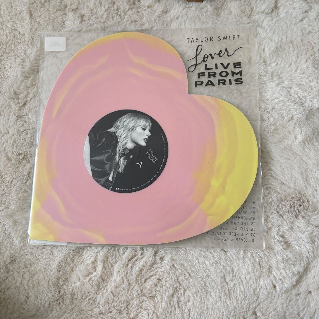 Taylor Swift Lover Live From Paris Vinyl (Category: Vinyls) located in Manila. Submitted by chapterthings (Listing ID 1404966114, Image 3). Description: Taylor Swift Lover Live From Paris vinyl record. It is a heart-shaped record with pink and yellow colors. The record is still in its original packaging. The item comes with the original packaging and a shipping label..