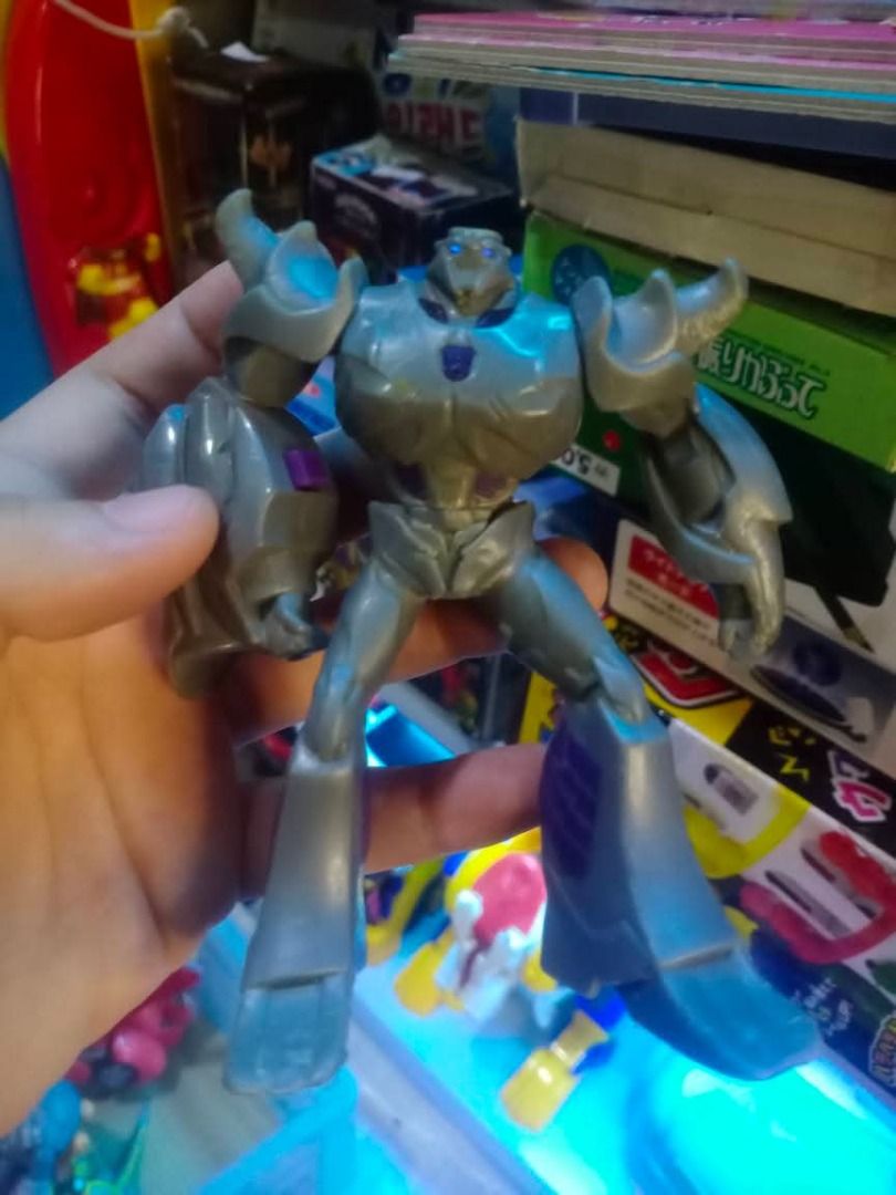 Transformers (Category: Action & Battle Toys) located in Tanza. Submitted by leonskidskorner (Listing ID 1405124899, Image 1). Description: - Transformers Animated Megatron action figure - Primarily gray with blue accents - Features the Decepticon logo - Standing pose with extended arms and legs - Well-detailed collectible item.