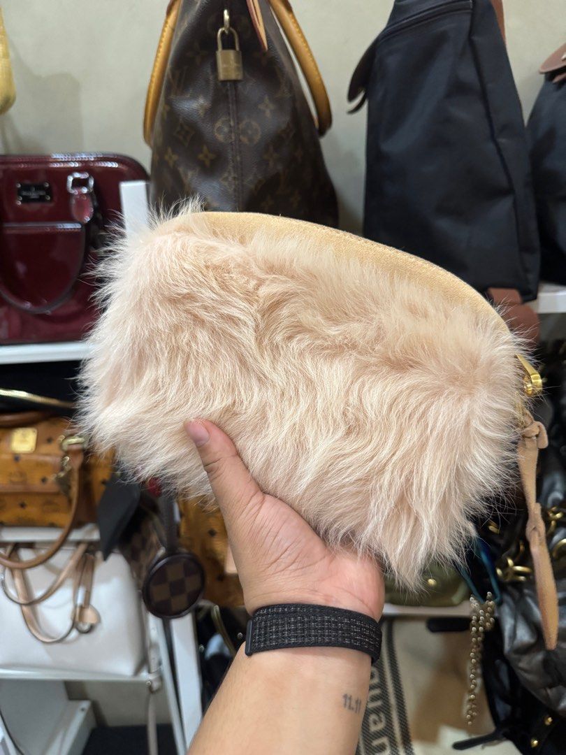 UGG Fur Clutch Bag (Category: Luxury Bags & Wallets) located in Cagayan de Oro. Submitted by KoaApparelAtbp. (Listing ID 1405155249, Image 1). Description: - Authentic UGG clutch bag - Soft fur exterior - Elegant beige color - Secure zip closure - Detachable strap for versatile carrying - Interior pocket for essentials - Gold-tone zipper adds a touch of luxury - UGG tag visible for authenticity - Comes with original cards.