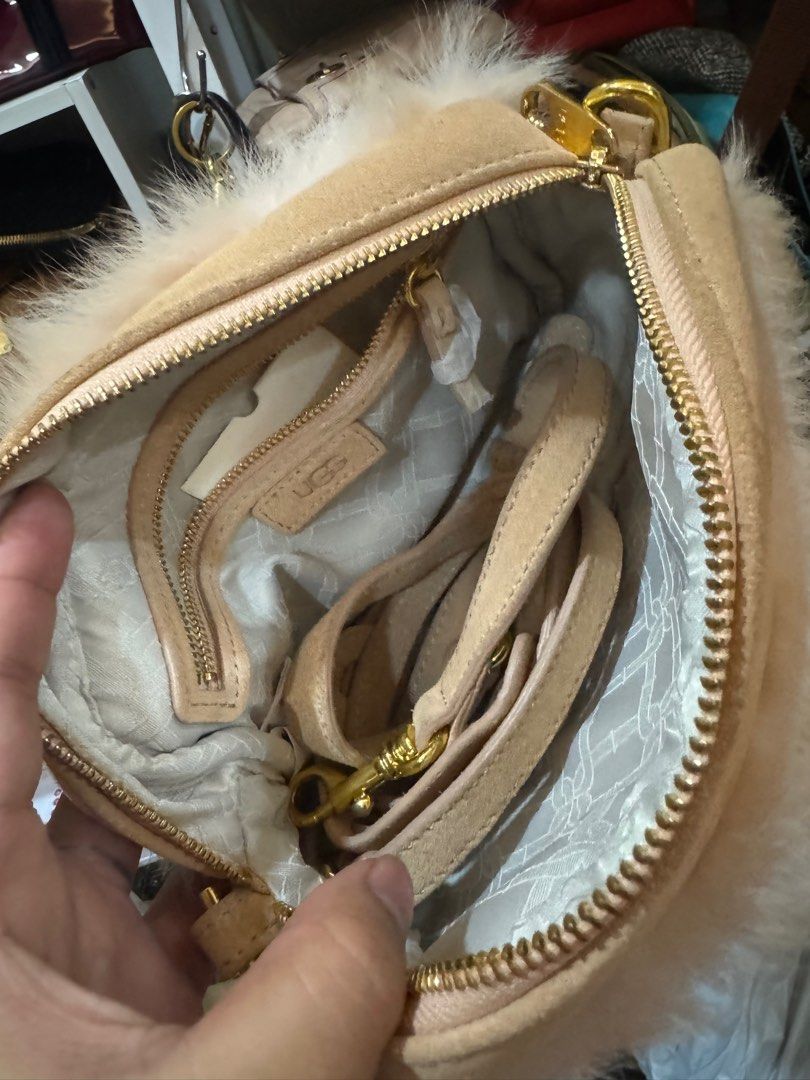 UGG Fur Clutch Bag (Category: Luxury Bags & Wallets) located in Cagayan de Oro. Submitted by KoaApparelAtbp. (Listing ID 1405155249, Image 3). Description: - Authentic UGG clutch bag - Soft fur exterior - Elegant beige color - Secure zip closure - Detachable strap for versatile carrying - Interior pocket for essentials - Gold-tone zipper adds a touch of luxury - UGG tag visible for authenticity - Comes with original cards.