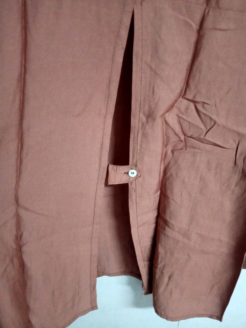 Brown Long Sleeve Blouse (Category: Blouses) located in Bulacan. Submitted by ely46 (Listing ID 1401846306, Image 3). Description: - Brown long-sleeved blouse - Collared neckline - Button-down front - Unique split back design with single button closure - Long sleeves with buttoned cuffs - Lightweight fabric - Suitable for warm weather - Brand new.