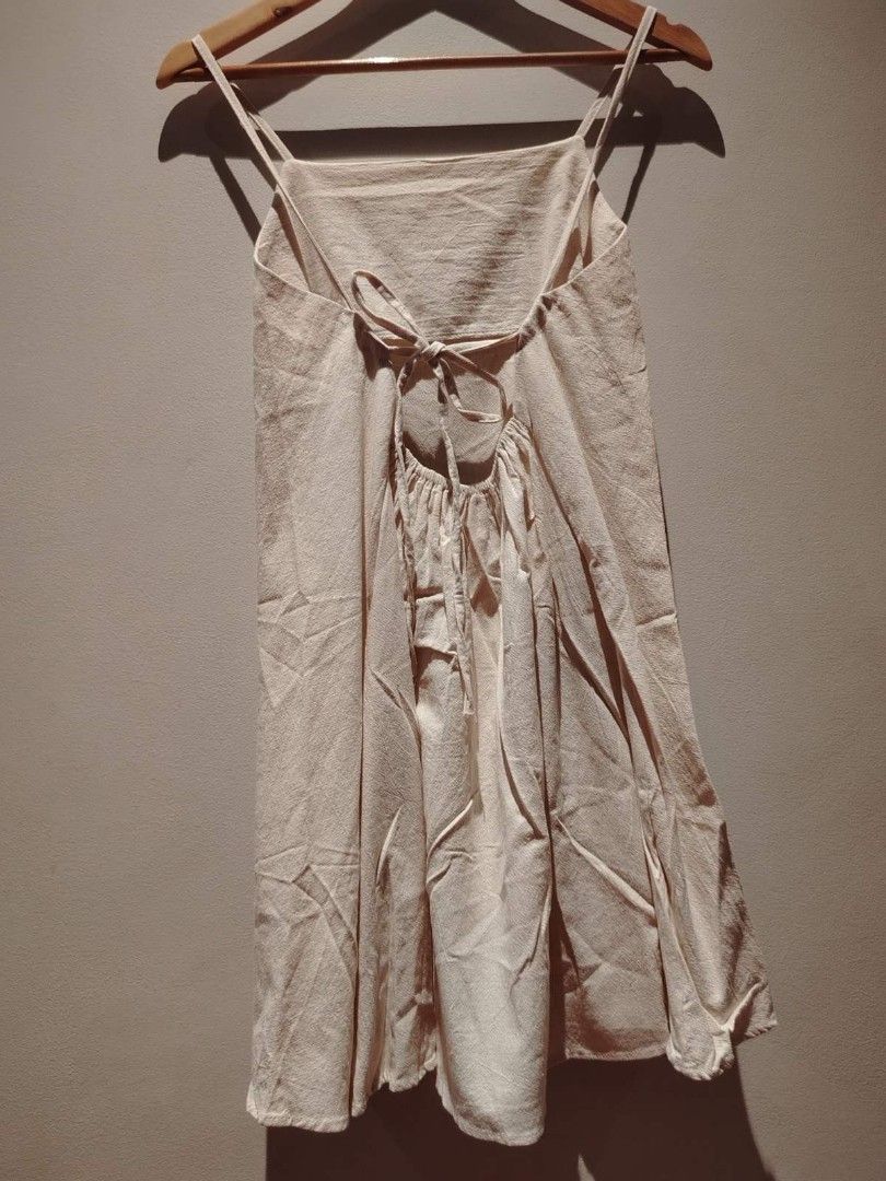 Cream-colored Spaghetti Strap Dress (Category: Dresses) located in Pasig City. Submitted by vthing (Listing ID 1401863324, Image 2). Description: - Cream-colored dress - Spaghetti straps - Square neckline - Tie back detail - Knee-length - Lightweight fabric - Versatile for various occasions.