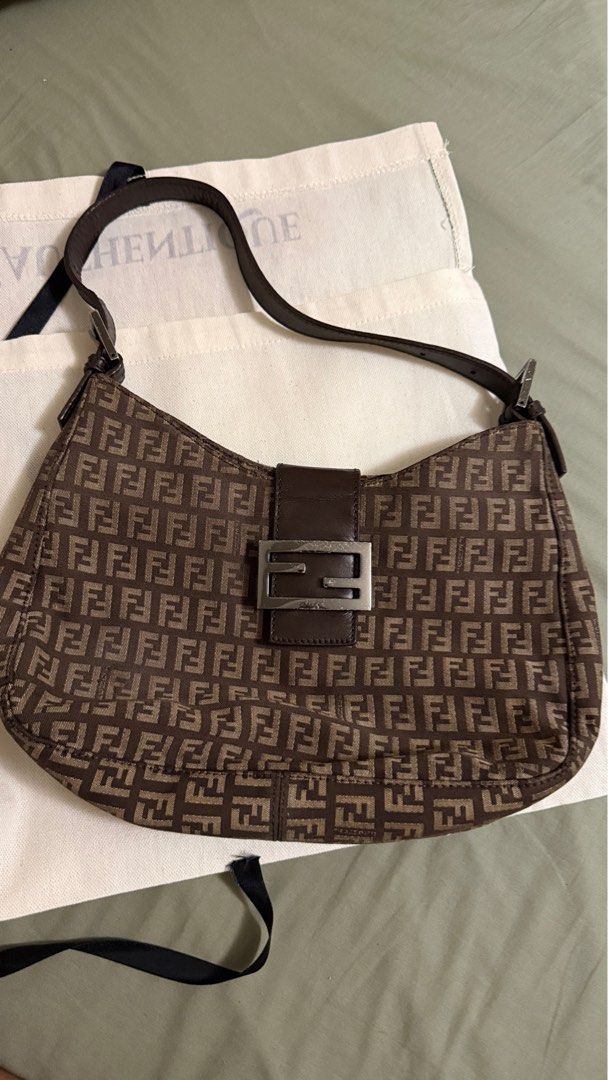 Fendi Vintage Shoulder Bag (Category: Luxury Bags & Wallets) located in Makati City. Submitted by mrypauline (Listing ID 1401832128, Image 1). Description: - Authentic Fendi shoulder bag - Iconic FF logo print in brown - Leather strap - Silver-tone buckle closure - Interior zippered pocket and small compartment Rfs: decluttering.