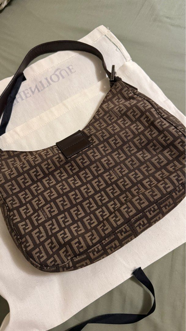 Fendi Vintage Shoulder Bag (Category: Luxury Bags & Wallets) located in Makati City. Submitted by mrypauline (Listing ID 1401832128, Image 3). Description: - Authentic Fendi shoulder bag - Iconic FF logo print in brown - Leather strap - Silver-tone buckle closure - Interior zippered pocket and small compartment Rfs: decluttering.