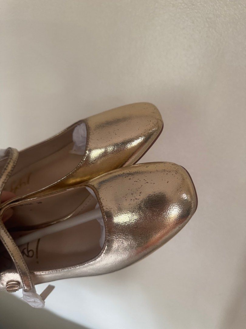 Gold Sofab Flats Mary Janes (Category: Flats & Sandals) located in Manila. Submitted by modernitaph (Listing ID 1401764402, Image 2). Description: - Gold-colored flats from SM Store - Size 38 - Square toe design - Strap across the top of the foot - Unworn condition - Original price: ₱1299.00 -issues: patches due to storage (see photo).