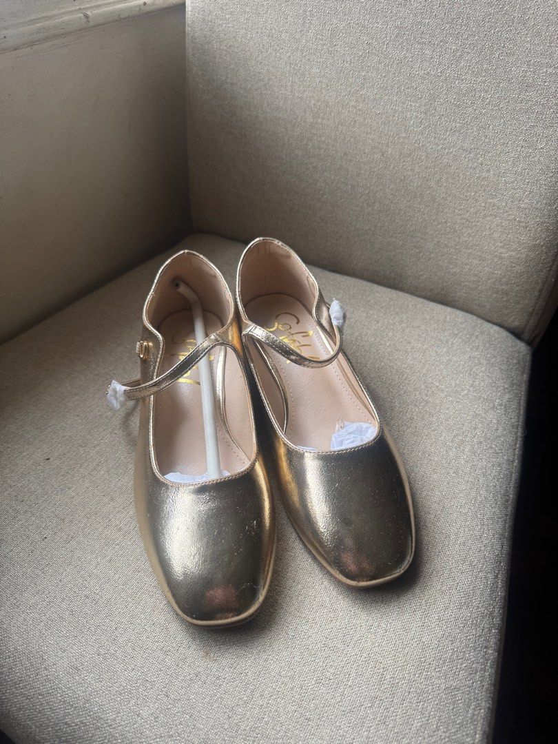 Gold Sofab Flats Mary Janes (Category: Flats & Sandals) located in Manila. Submitted by modernitaph (Listing ID 1401764402, Image 1). Description: - Gold-colored flats from SM Store - Size 38 - Square toe design - Strap across the top of the foot - Unworn condition - Original price: ₱1299.00 -issues: patches due to storage (see photo).