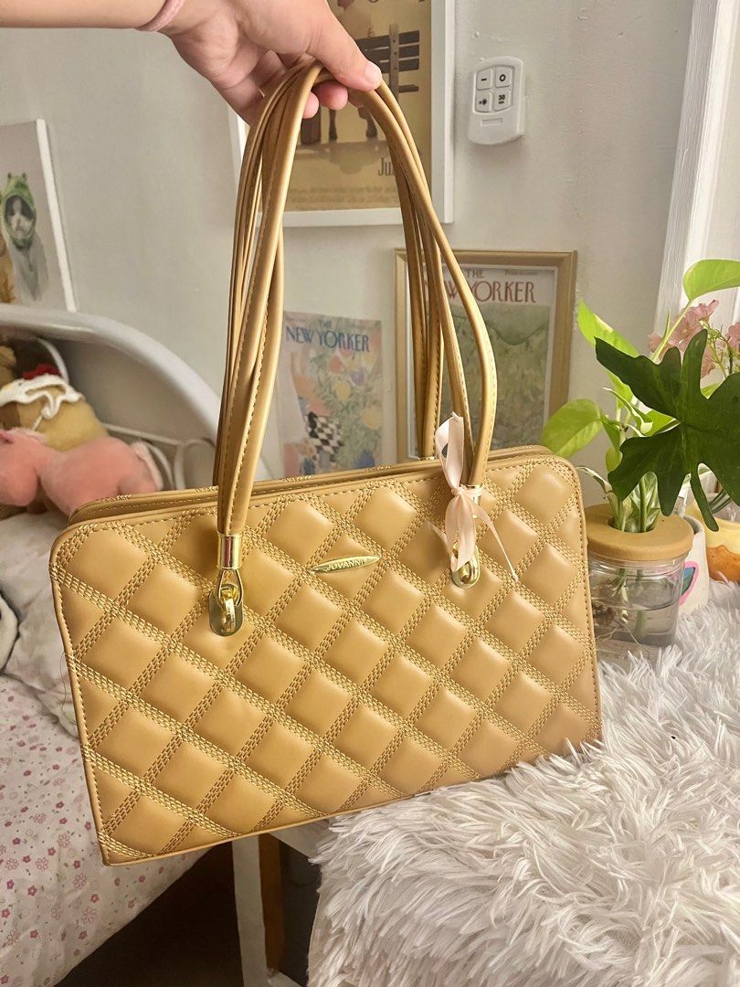 Jovanni Quilted Handbag (Category: Luxury Bags & Wallets) located in Manila. Submitted by revdeclutter (Listing ID 1401877795, Image 1). Description: Tan Jovanni handbag with quilted design. Features double handles and gold hardware. Includes tag. Rectangular shape. .