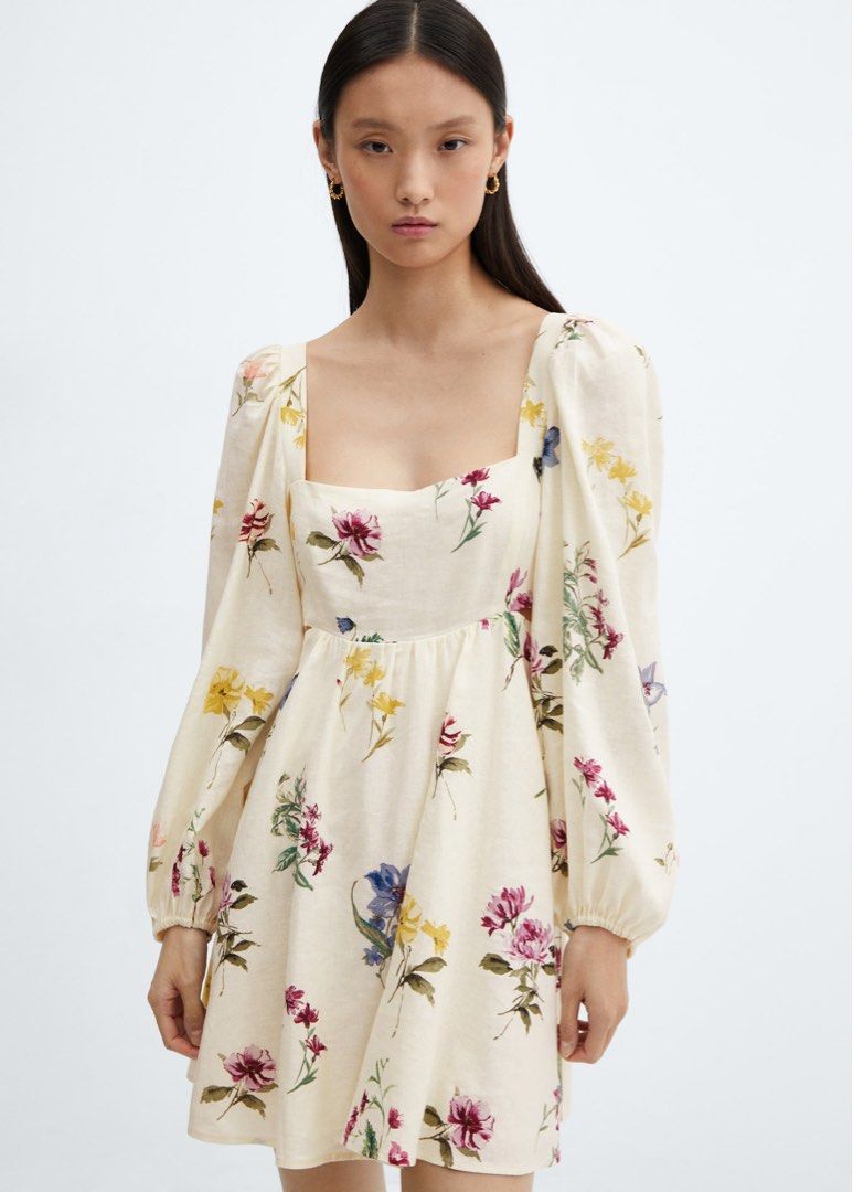 Mango Floral Print Mini Dress (Category: Dresses) located in Taguig. Submitted by summershop2021 (Listing ID 1401827999, Image 1). Description: Mini dress features a square neckline and long sleeves with a gathered cuff. It has a fitted bodice and a flared skirt. The dress is adorned with a colorful floral print. It also has cut-out details on the sides. Perfect for a casual day out or a special occasion..