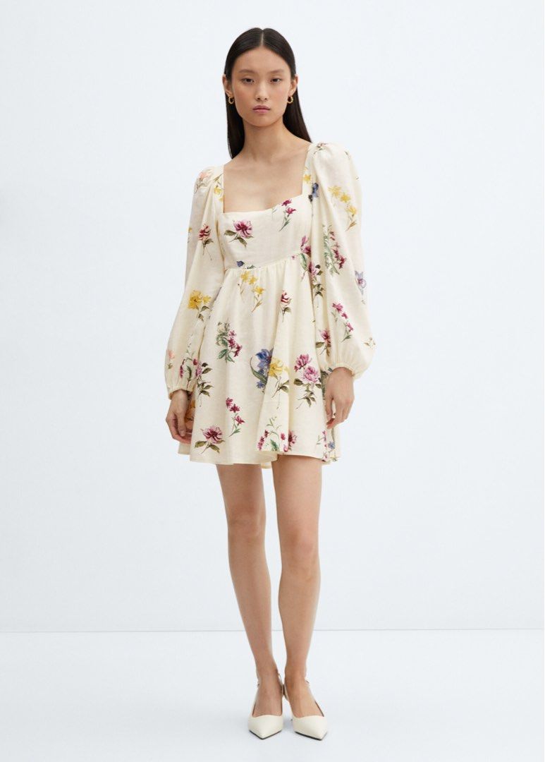 Mango Floral Print Mini Dress (Category: Dresses) located in Taguig. Submitted by summershop2021 (Listing ID 1401827999, Image 2). Description: Mini dress features a square neckline and long sleeves with a gathered cuff. It has a fitted bodice and a flared skirt. The dress is adorned with a colorful floral print. It also has cut-out details on the sides. Perfect for a casual day out or a special occasion..