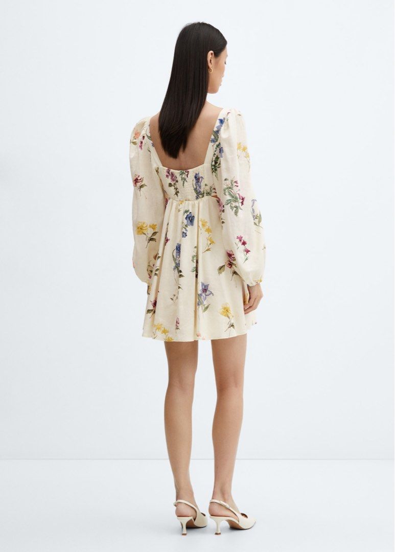 Mango Floral Print Mini Dress (Category: Dresses) located in Taguig. Submitted by summershop2021 (Listing ID 1401827999, Image 3). Description: Mini dress features a square neckline and long sleeves with a gathered cuff. It has a fitted bodice and a flared skirt. The dress is adorned with a colorful floral print. It also has cut-out details on the sides. Perfect for a casual day out or a special occasion..