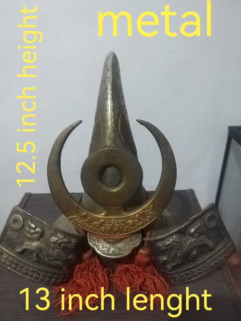 Metal Samurai Helmet - 12.5 inch Height (Category: Vintage Collectibles) located in San Rafael. Submitted by jflshoppe1989 (Listing ID 1401718435, Image 1). Description: Metal samurai helmet features a distinctive design with a 12.5-inch height and 13-inch length. It has intricate details, including decorative elements and tassels. It is a striking piece for display or collection..