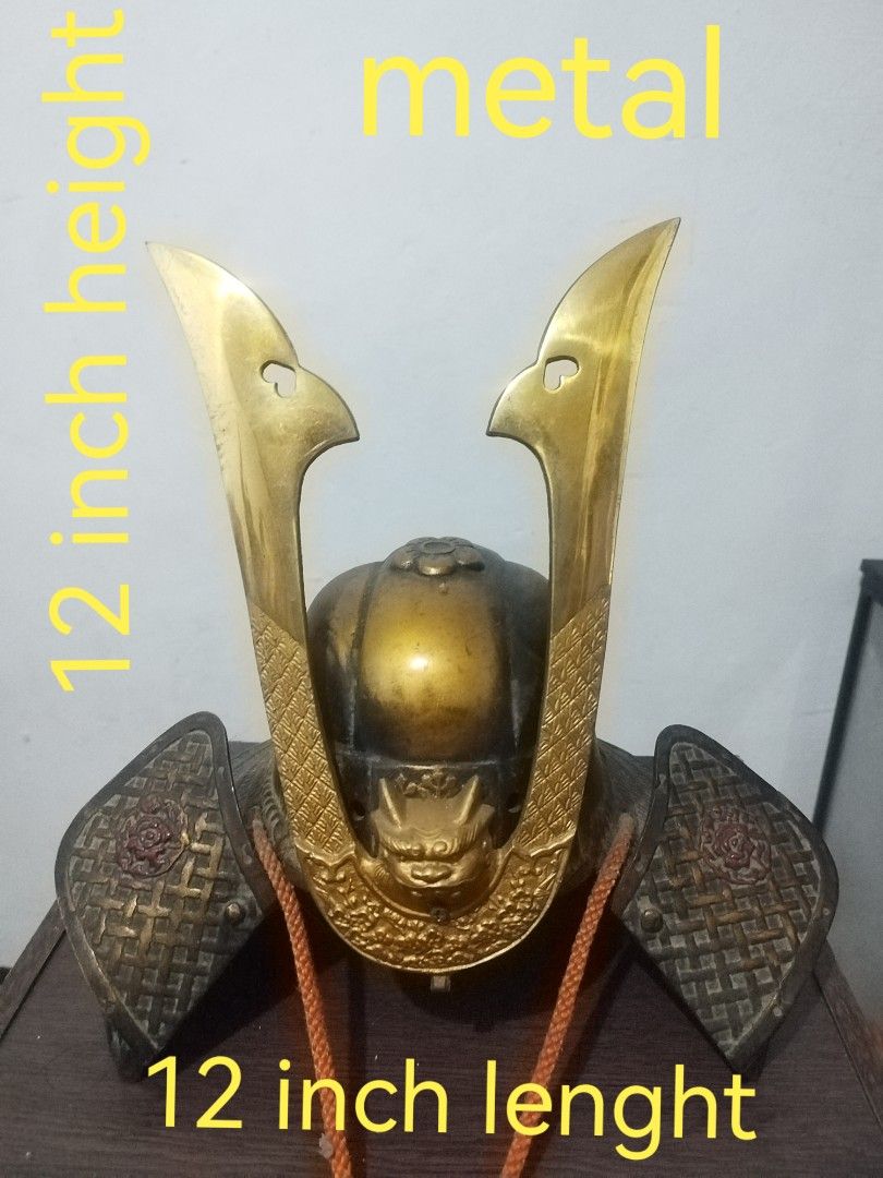 Metal Samurai Helmet - 12 inch (Category: Vintage Collectibles) located in San Rafael. Submitted by jflshoppe1989 (Listing ID 1401718649, Image 1). Description: Metal samurai helmet. It has a gold-colored finish and intricate details. The helmet is approximately 12 inches in height and 12 inches in length. It features decorative elements and a detailed face guard..